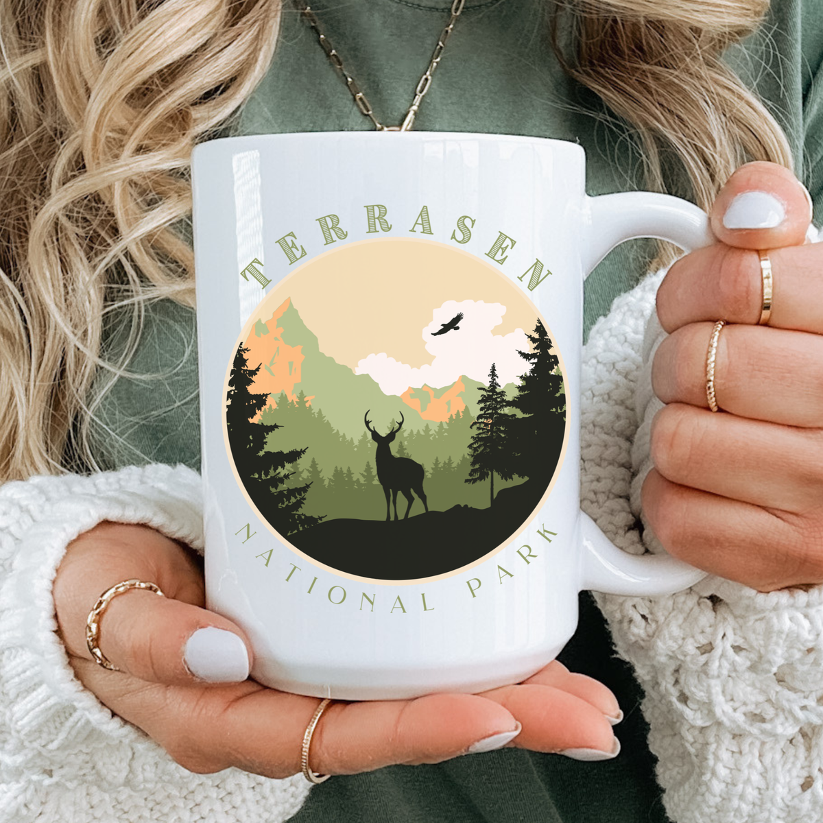 Hands holding the Terrasen National Park mug — Throne of Glass merch inspired by Sarah J. Maas
