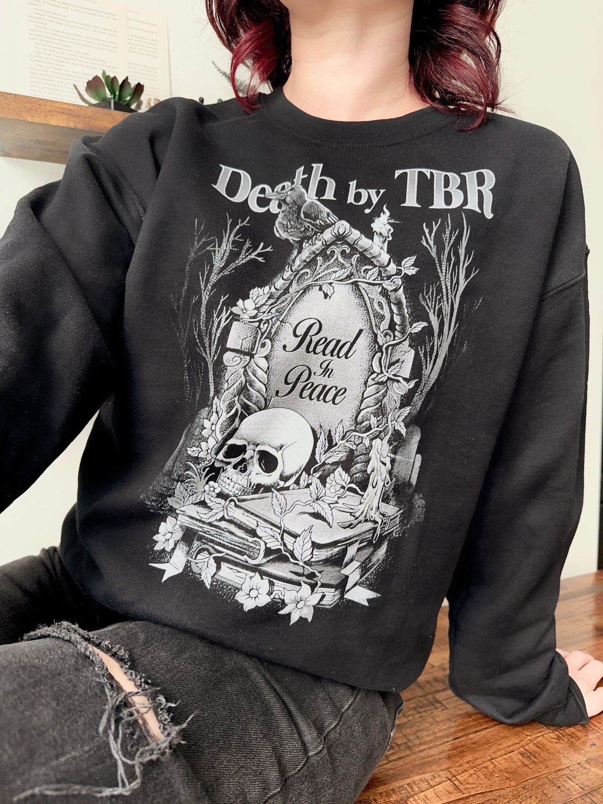 Death By TBR Sweatshirt — bookish merch by Caffeine and Curses. The to-be-read pile that will outlive us all. Hand-designed in Australia.