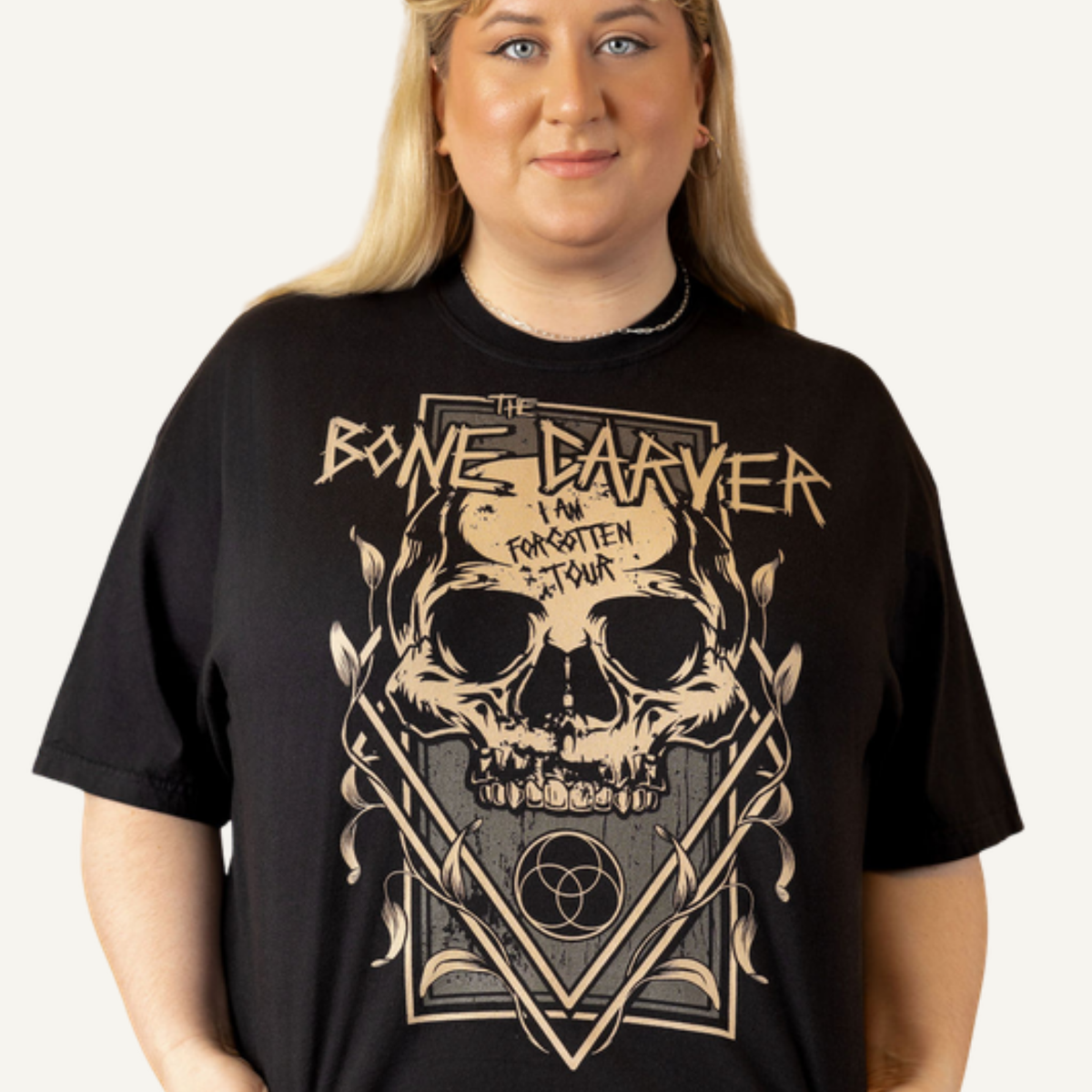 Bone Carver T-Shirt in black on a model — 'I Am Forgotten Tour' skull print, front view. ACOTAR merch.