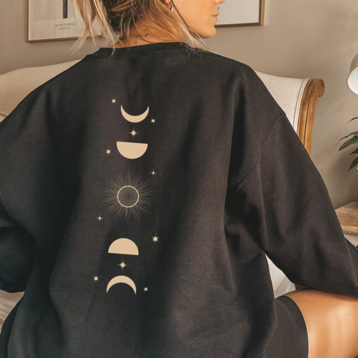 Back view of a black Feyres Tattoo sweatshirt with the gold moon phase spine print, ACOTAR merch inspired by Sarah J. Maas
