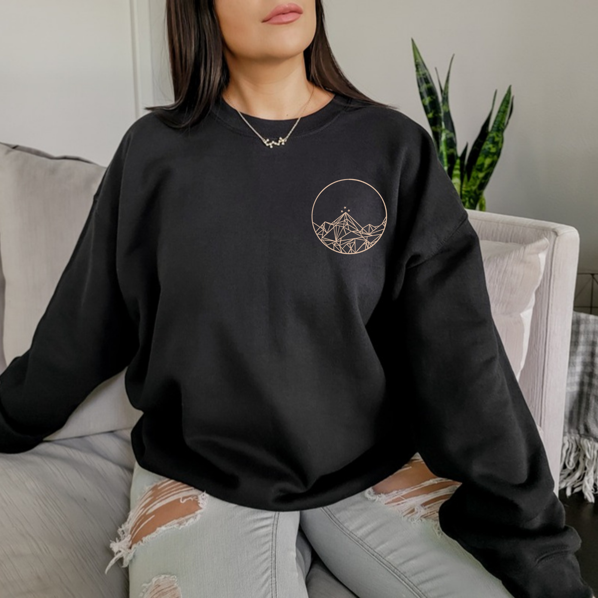 Front of a black Feyres Tattoo sweatshirt with the gold Night Court mountain circle on the chest, ACOTAR merch inspired by Sarah J. Maas