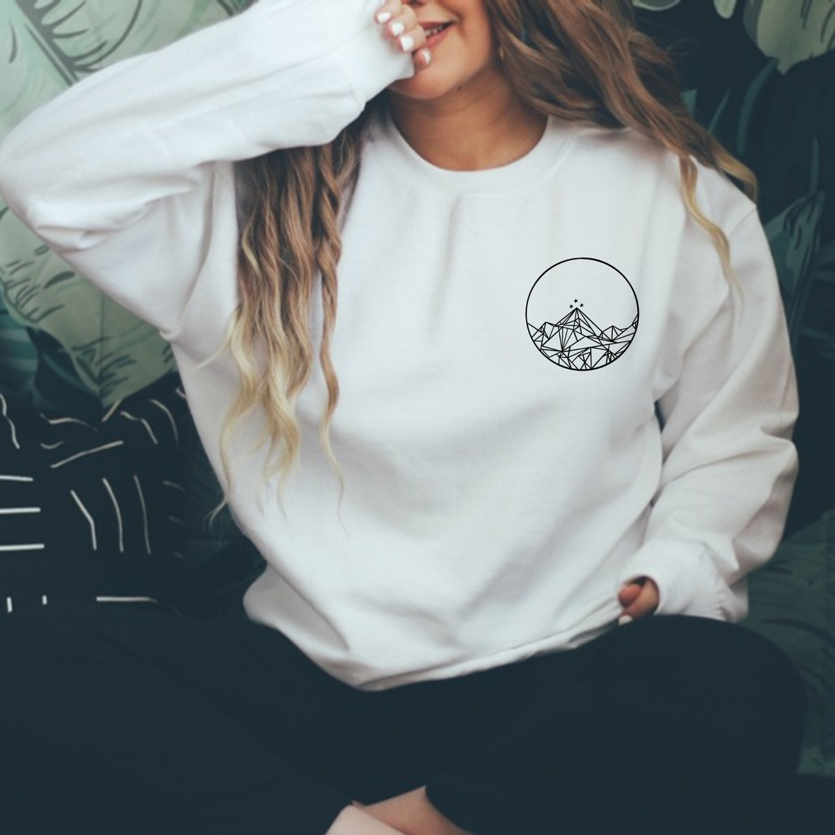 Front of a white Feyres Tattoo sweatshirt with the small Night Court mountain circle on the chest, ACOTAR merch inspired by Sarah J. Maas