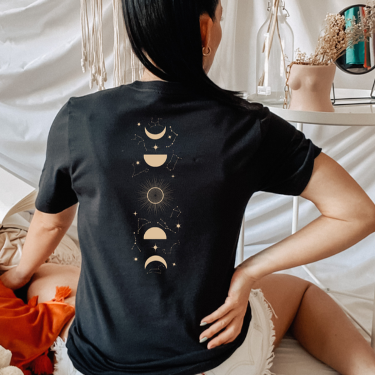 Back view of a black Feyres Tattoo t-shirt with the gold moon phase and constellation spine print, ACOTAR merch inspired by Sarah J. Maas