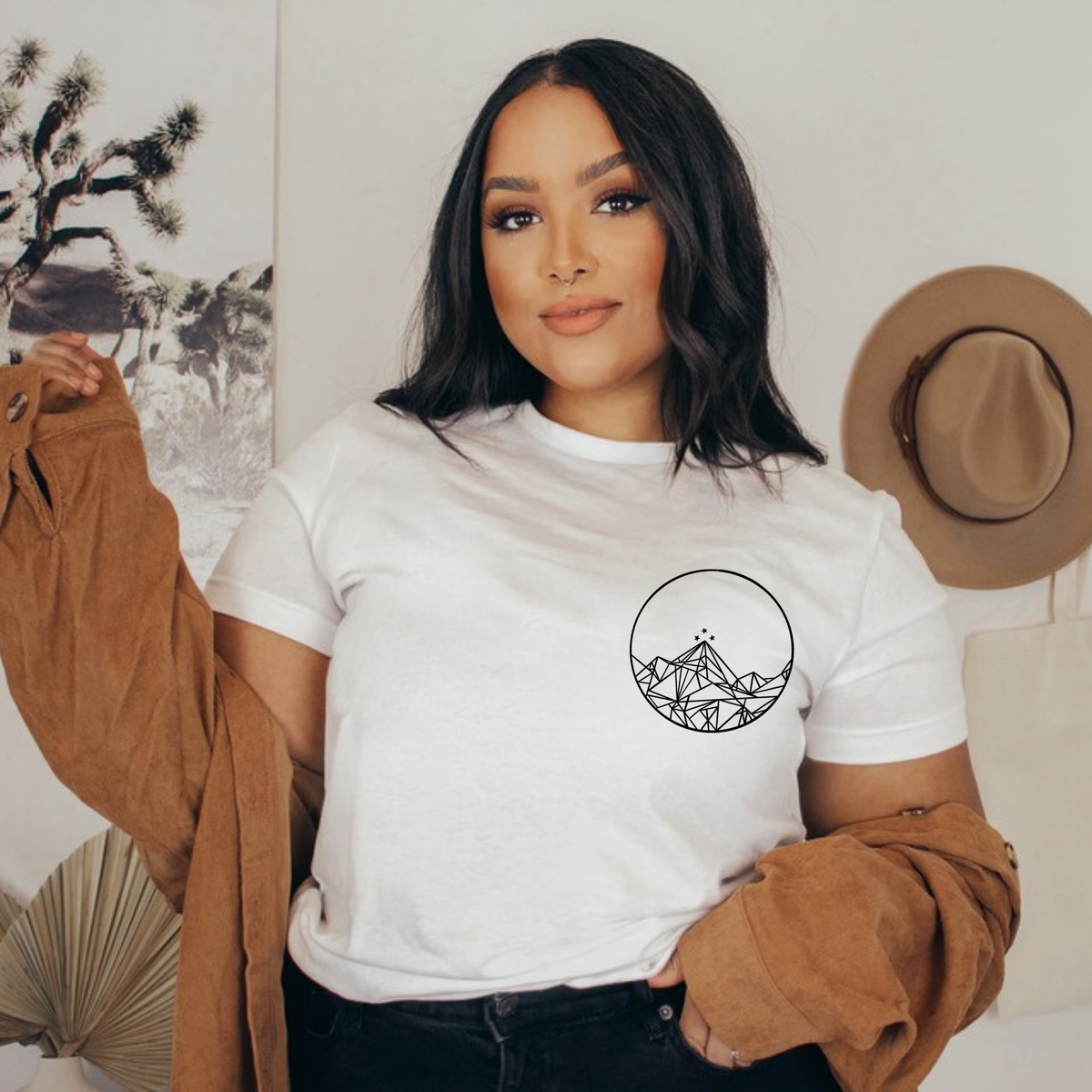 Front of a white Feyres Tattoo t-shirt with the small Night Court mountain circle on the chest, ACOTAR merch inspired by Sarah J. Maas