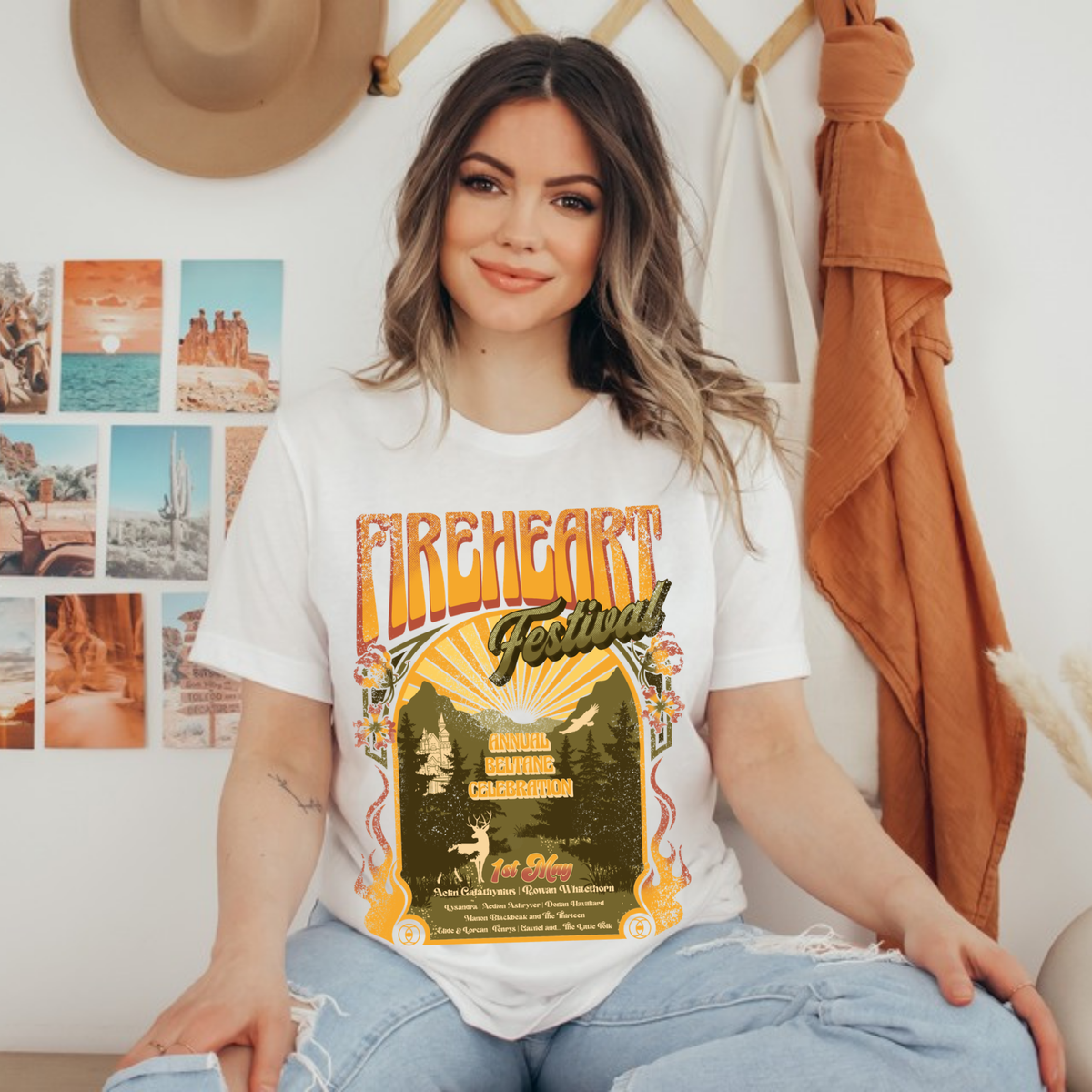 Model seated wearing a Fireheart Festival t-shirt with the retro Beltane poster print, inspired by Throne of Glass by Sarah J. Maas