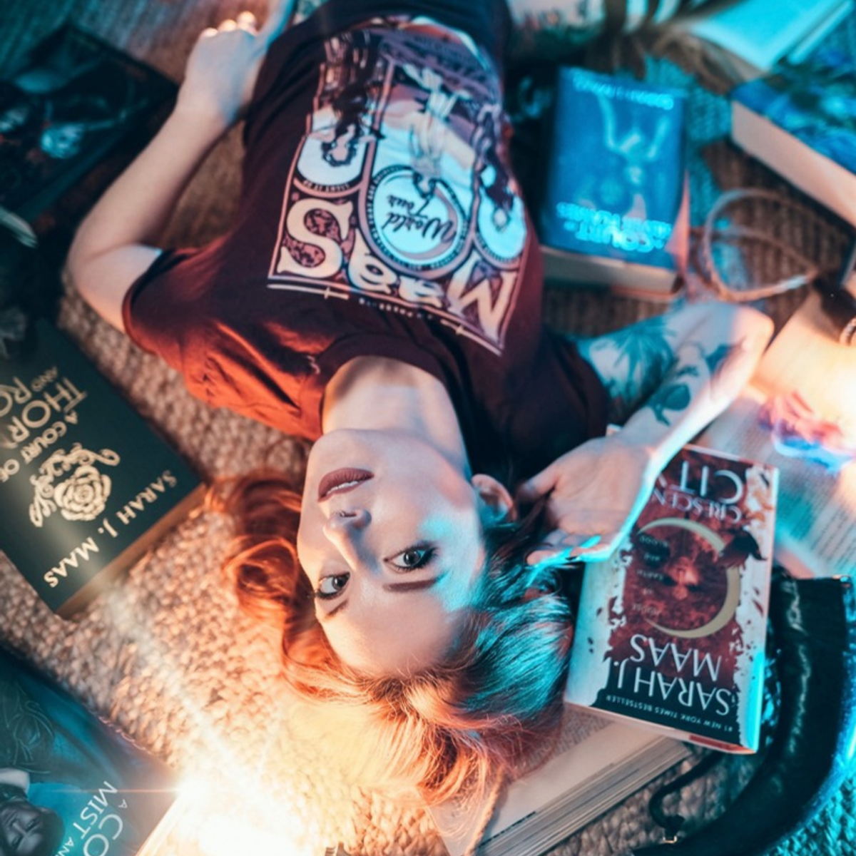 Maroon Maas World Tour t-shirt styled with Sarah J. Maas books, merch inspired by the worlds of Sarah J. Maas