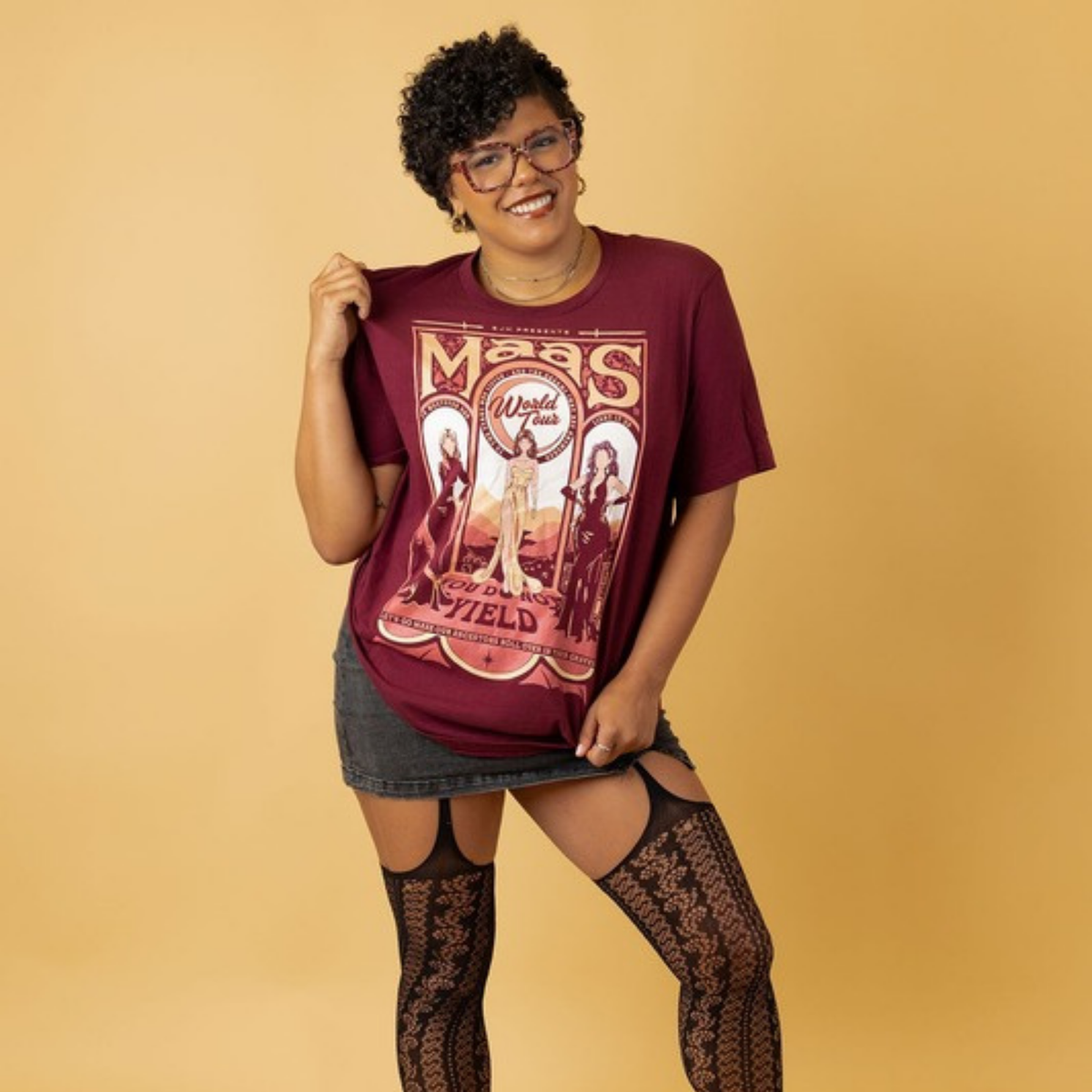 Model in the maroon Maas World Tour t-shirt, merch inspired by the worlds of Sarah J. Maas