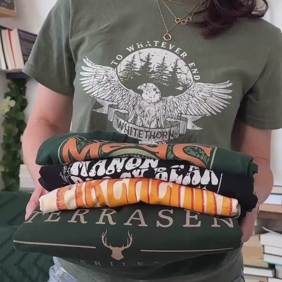 Try-on video: the Rowan Whitethorn tee worn, held with the Maas, Manon Blackbeak, Fireheart and Terrasen designs