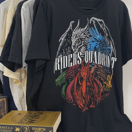 Product video: the black Riders Quadrant t-shirt back print — the four dragons in a ring, white, blue, green and red, around the RIDERS QUADRANT lettering [focal 50 40]