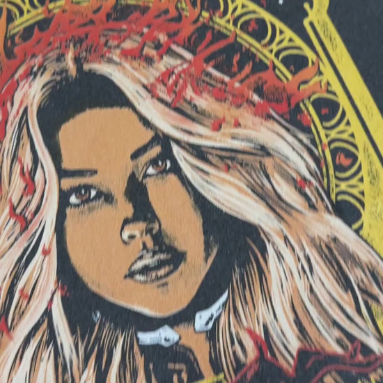 Product video: the Lidia Cervos t-shirt in close — the yellow art-nouveau frame around her portrait, 'LIDIA CERVOS PRESENTS' above and 'AGENT DAYBRIGHT' beneath [focal 50 45]