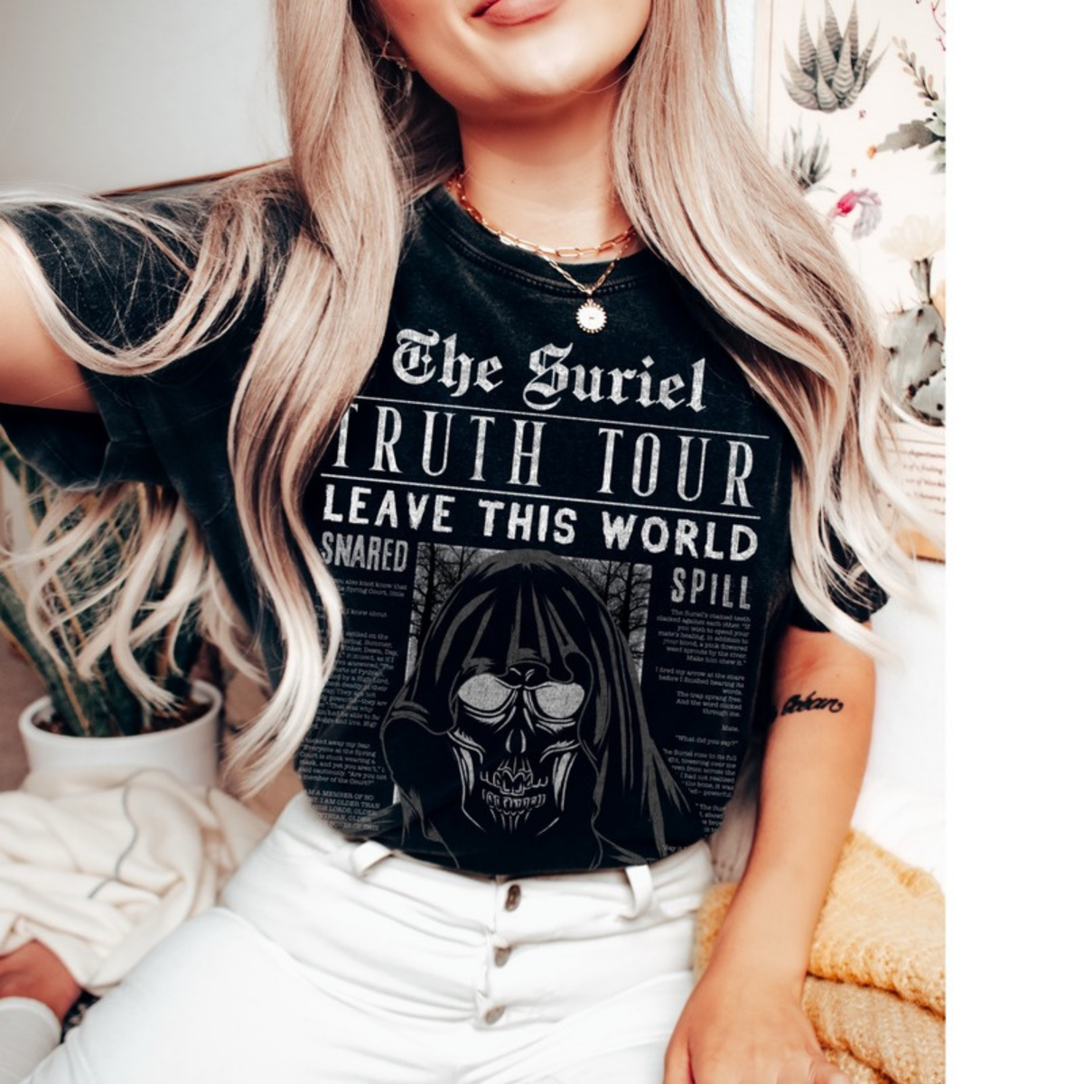 The Suriel T-Shirt in washed black, styled with white jeans. ACOTAR merch.
