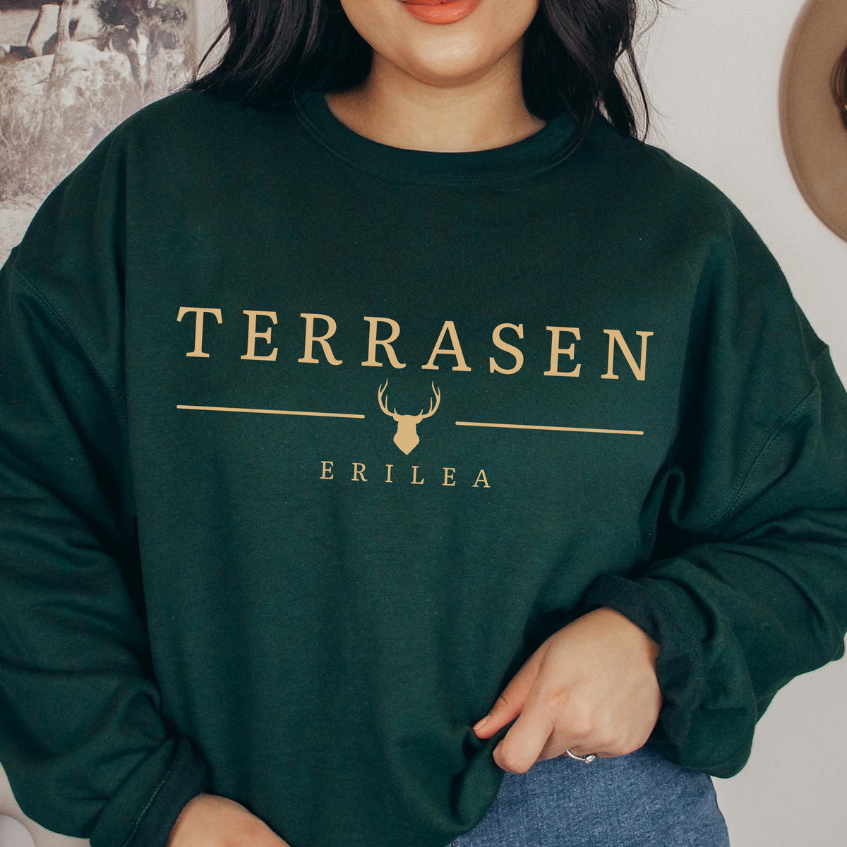 Model wearing the forest green Terrasen sweatshirt — Throne of Glass merch inspired by Sarah J. Maas